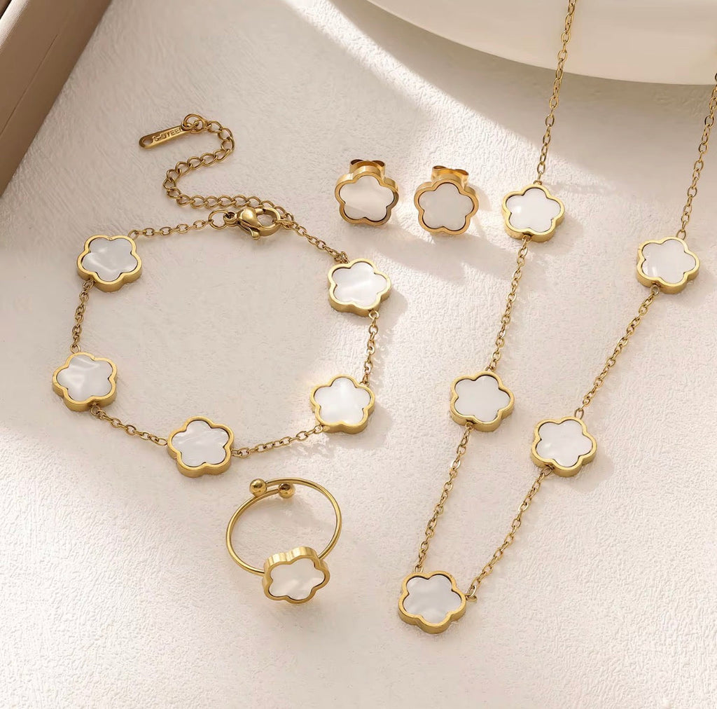18K Gold Plated Black Clover 4-Piece Jewelry Set on dark display