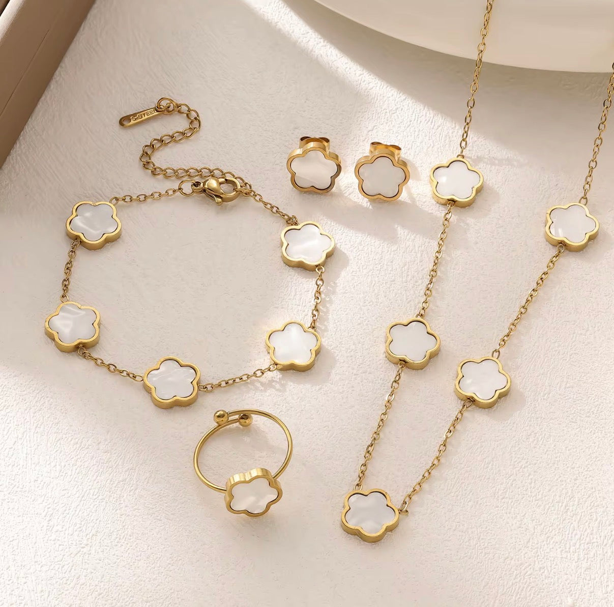 18K Gold Plated Black Clover 4-Piece Jewelry Set on dark display